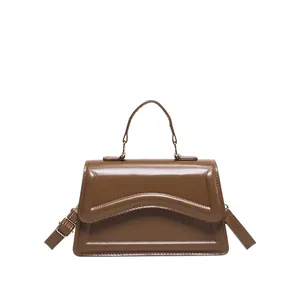 Fashionable minimalist brown gloss leather crossbody handbag with top handle and gold hardware