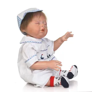 Lifelike reborn baby doll sleeping in white sailor outfit and blue plaid hat with socks