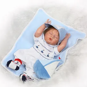 Realistic sleeping reborn baby doll in nautical blue outfit and matching sun hat