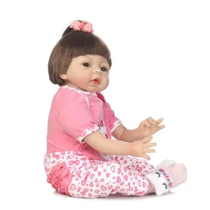 Lifelike soft vinyl reborn baby doll for girls with pink floral outfit and bow headband