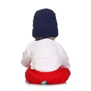 Lifelike baby doll in cute penguin outfit with navy hat, white shirt and red pants
