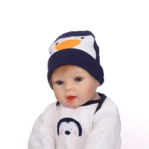 Lifelike reborn baby doll in cute blue penguin outfit with matching hat and white cotton top
