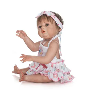 Lifelike reborn baby doll in floral sweet-treat print dress with matching bow headband