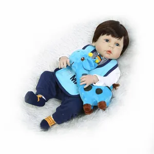 Realistic newborn baby boy doll with blue eyes and giraffe plush toy on rug