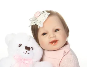 Close-up of realistic reborn baby doll with lace headband and soft knit sweater