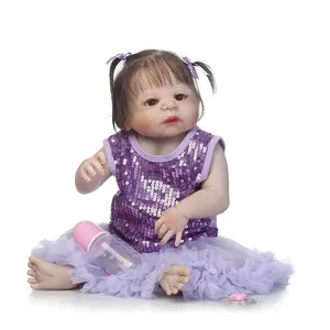 Realistic baby doll with pigtails in purple sequin dress with bottle and pacifier
