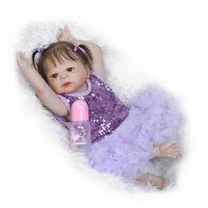 Realistic reborn baby doll girl with brown hair in purple sequin dress and tutu