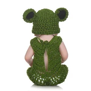 NPK full silicone reborn baby doll wearing a green handmade crochet outfit set