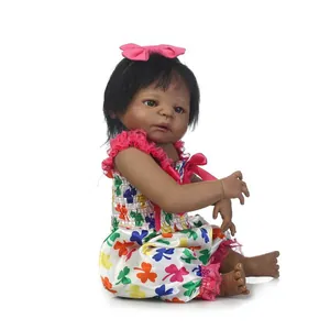 Lifelike black newborn baby doll with pink headband and floral print lace dress