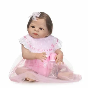 Realistic reborn baby doll in pink lace dress with nursing bottle and headband