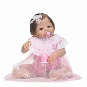 Realistic reborn baby doll girl with pink lace dress, floral headband, and feeding set