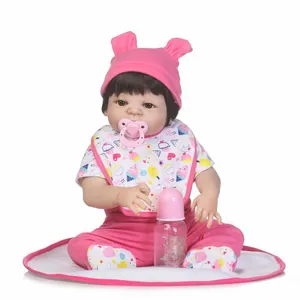 Lifelike reborn baby doll in pink ice cream outfit with bottle and pacifier accessories