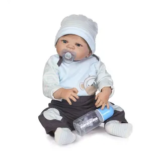 Realistic reborn baby doll in blue striped outfit with pacifier and feeding bottle