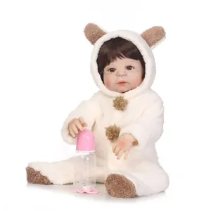 Realistic reborn baby doll in white plush bear outfit with bottle and pacifier
