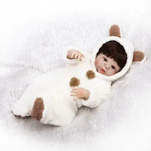 Realistic reborn baby doll in soft white teddy bear romper on white plush carpet