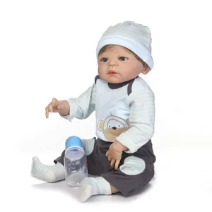 Realistic reborn baby doll in blue monkey outfit with feeding bottle accessory