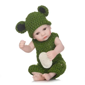 Handmade frog crochet outfit with hat and bodysuit on a lifelike reborn baby doll