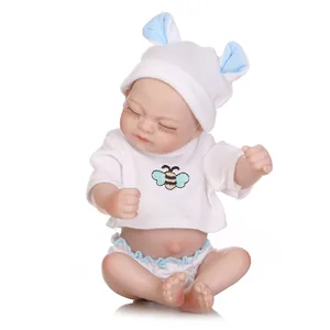Lifelike reborn baby doll in white bee outfit with closed eyes for imaginative play