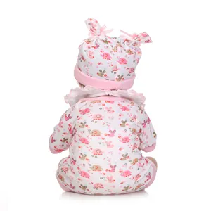 Back view of a realistic newborn doll in a pink elephant pattern romper and matching hat