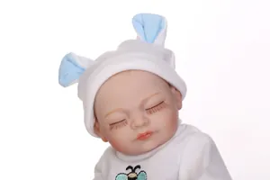 Close-up of sleeping reborn baby doll featuring long eyelashes and a blue bunny ear hat