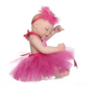 Realistic sleeping reborn baby doll in pink tutu and flower headband on white background