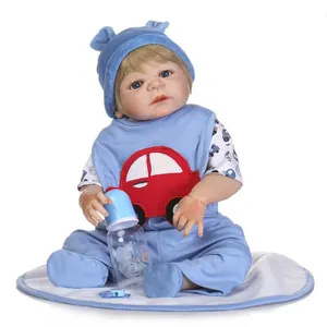 Realistic 0-3 months baby doll with blue eyes and blue car outfit sitting on a white mat
