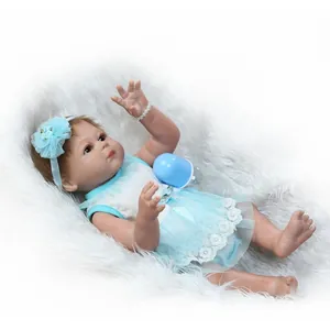 Realistic reborn baby doll in blue lace dress with matching headband and feeding bottle