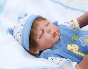 Detailed view of lifelike rebirth doll in blue giraffe romper with realistic skin texture