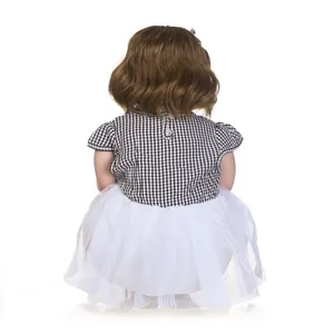 Realistic reborn toddler doll in black and white checkered top and white tutu skirt