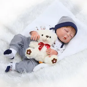 Realistic reborn baby doll in blue striped outfit sleeping on a white faux fur rug