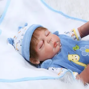 Sleeping reborn baby doll in blue giraffe outfit resting on a soft white plush rug