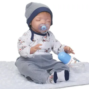 Lifelike sleeping reborn doll with blue striped outfit, pacifier and bottle on white fur