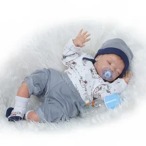 Lifelike reborn baby doll in blue striped outfit with magnetic pacifier and bottle
