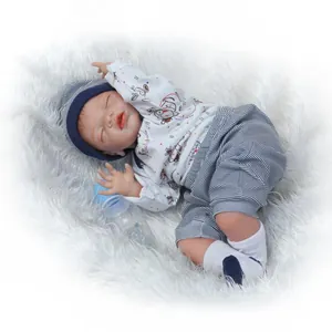 Realistic sleeping baby reborn doll with blue striped hat and cute puppy print outfit