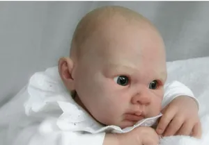 Realistic reborn baby doll with lifelike skin texture and delicate lace white outfit