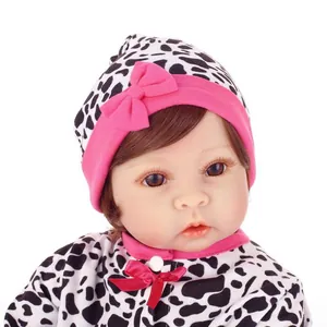Realistic reborn baby doll in black and white leopard print outfit with pink bows