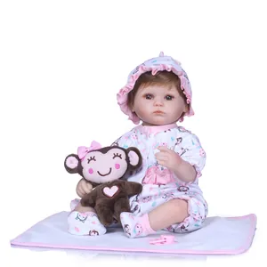 Realistic reborn doll in floral outfit with monkey plush and pink pacifier