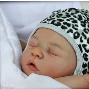 Realistic newborn reborn doll kit with leopard print hat sleeping on white cotton blanket