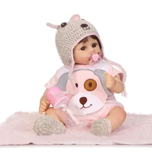 Realistic reborn baby doll in pink striped outfit with pacifier and bottle accessories