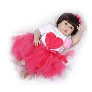 Realistic reborn baby doll girl in red tutu and heart shirt on white plush rug