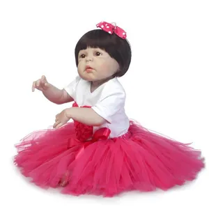 Realistic reborn baby doll in white heart t-shirt and fluffy hot pink tutu skirt