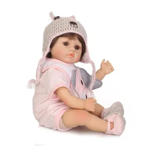 Realistic reborn baby doll in pink elephant outfit with knitted grey hat and socks