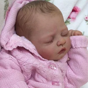 Reborn doll kit prototype featuring a sleeping baby in a pink knit cardigan