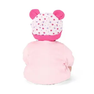 Cute lifelike reborn baby doll in pink knit top with floral bear-ear hat on white background