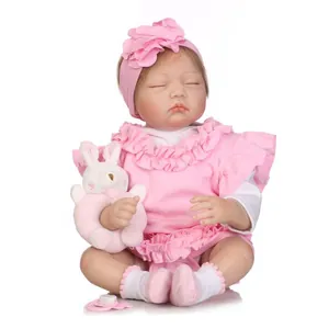Poupée réaliste bébé endormi en tenue rose fleurie avec accessoire hochet lapin