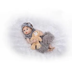Poupée reborn réaliste en tutu gris à paillettes avec un ours en peluche marron