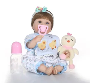 Close-up of lifelike reborn doll with floral outfit, bib, pacifier, and toy duckling