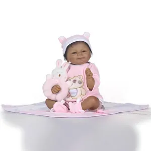 Poupée Reborn réaliste à la peau foncée portant une tenue rose avec motif d'ours
