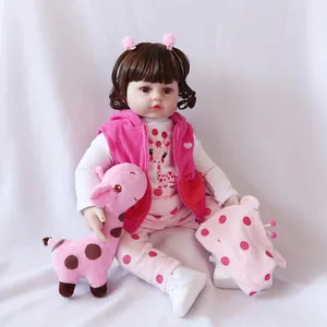 Lifelike reborn baby doll in pink fleece vest with matching plush giraffe toy