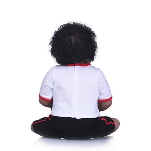 Realistic dark skin baby doll with curly black hair in sporty red and white outfit